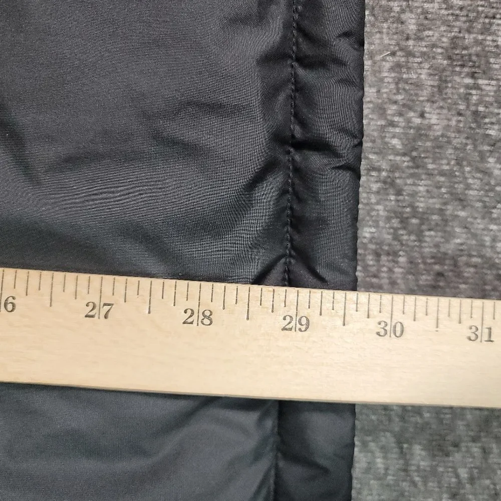 Premium insulated puffer vest by The North Face featuring embroidered Synchrony